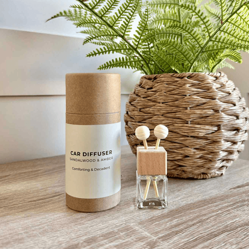 Refreshing fern and wicker car diffuser with sandalwood and amber fragrance for luxury scent experience.